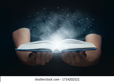 Man opened a magic book with growing lights and magic powder. Learning and education concept. - Shutterstock ID 1714202521