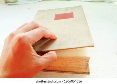  A Man Is Opening A Book. 