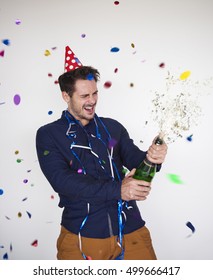 Man Opening A Bottle Of Champagne