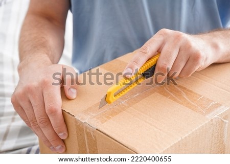 Man opening box with utility box, closeup