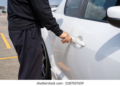 A Man Opening A Car Door.