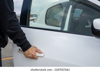 A Man Opening A Car Door.