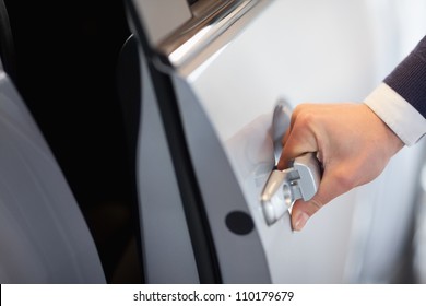 Man Opening A Car Door In A Garage