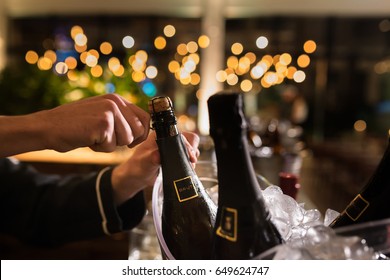 Man Opening Champagne Bottle In A Wedding Party