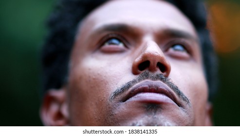 Man Opening Eyes Looking Up To Sky. Close-up Of African American Person Feeling Hope And Faith