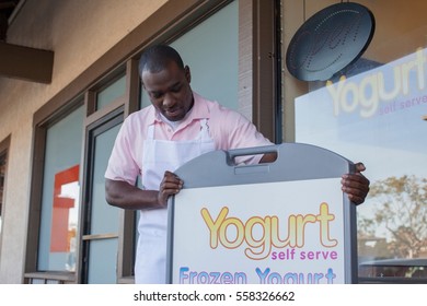 Man Opening Frozen Yogurt Store