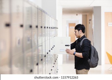 Man opening his locker at college