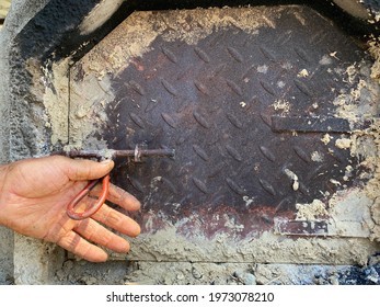 Man Opening The Iron Oven Door