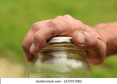 Man Opening Jar Lid With Hand