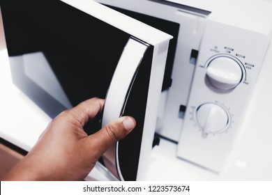 Man Opening Microwave Oven Door