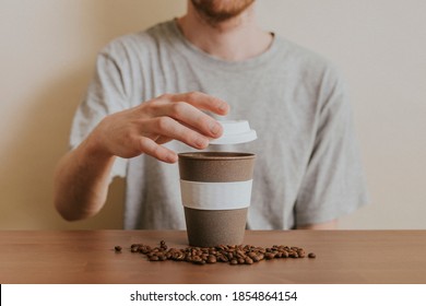 Man Opening A Reusable Coffee Cup