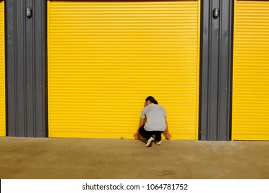 Man Opening The Shutter Door