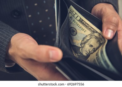 A Man Opening Wallet Showing Some Money, 20 US Dollar Bill Left