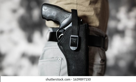 Man Openly Carrying A Revolver In A Holster On His Belt. Open Carry And Second Amendment Concept.