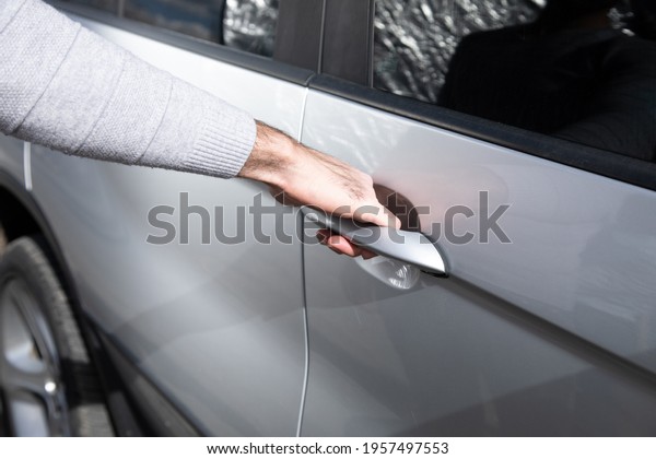 a man opens a car\
door
