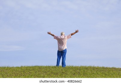 The man opens his arm, enjoy the fresh air and embrace the nature. - Powered by Shutterstock