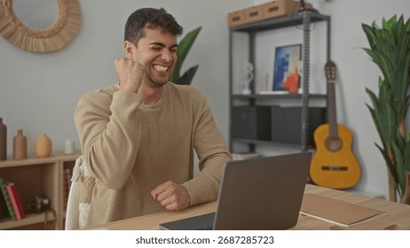 Man opens laptop while typing messages at home where young hispanic male enjoys computer sessions in a room workspace.