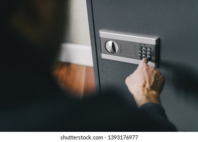 man opens safe, combination lock