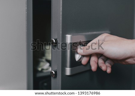 man opens safe, combination lock safe,  key combination, savings storage