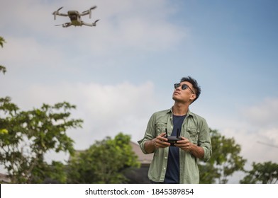 Man operating drone by remote control. Drone Pilot.