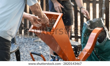 man operating a wood chipper