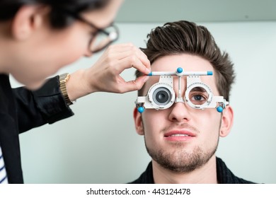 Man With Optician At Eyesight Test For Glasses