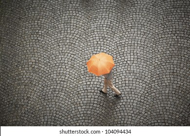 Man With Orange Umbrella In Rain.