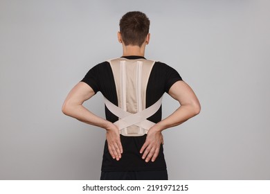 Man With Orthopedic Corset On Grey Background, Back View