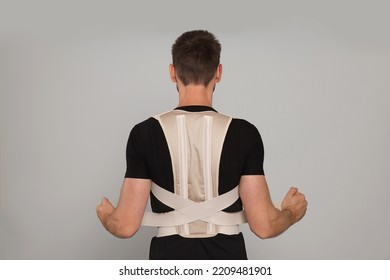 Man With Orthopedic Corset On Grey Background, Back View