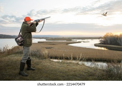 Man Out Hunting. Hunter Hunting Duck In Autumn Season At Sunrise.