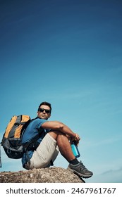 Man, outdoor and thinking with backpack on rock with thoughts, relax and serenity on adventure for solitude in nature. Person, hiking and mountain cliff with mock up, peace or calm and sustainability