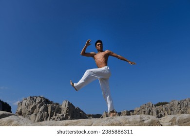 Man outdoors blue sky background. Summer trends. Male beauty concept. , . Muscular body. Fitness model - Powered by Shutterstock