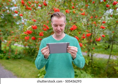 Man outdoors using digital tablet