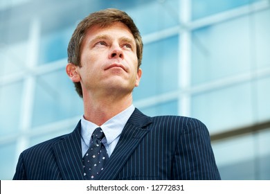 Man Outside Office Building, Looking Up