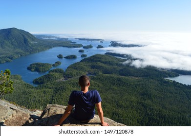 Man Overlooking The Pacific Rim Coastline