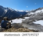 Man overlooking valley and mountain range in Glacier National Park. British Columbia, Canada.