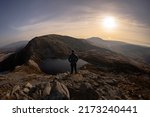 A man overlooking a Welsh mountain lake in Snowdonia Rhinogydd