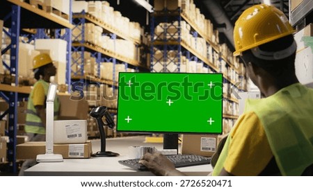 Man overseeing distribution activity and protocols with mockup on pc, working on large scale industrial operations for retail e-commerce industry. Storehouse with boxes on racks. Camera A.