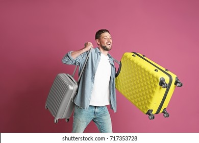 Man With Overweight Luggage On Colorful Background