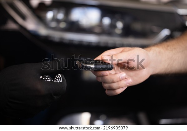 Man owner\
of the auto gives the keys to the car repairman. Close up shot of\
hands of male client giving car key to mechanic in auto repair\
shop. Car repair. Vehicle breaks\
down.