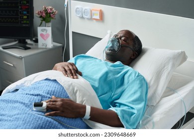 Man in oxygen mask lying in hospital - Powered by Shutterstock