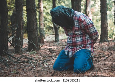 Man With A Package On His Head In The Forest. Victim Of Crime. Murder.