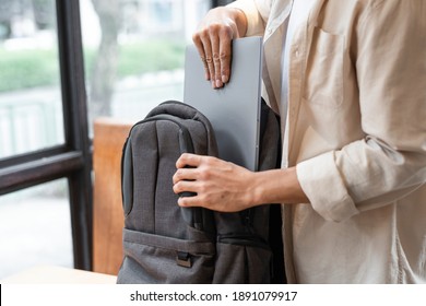 Man Packing Away His Laptop Into A Bag