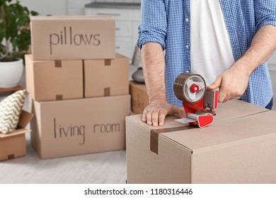 Man packing moving box indoors, closeup. Space for text - Shutterstock ID 1180316446