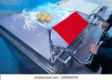 Man Packs Convenience Foods. Vacuum Pouch Packaging. Machine For Removing Air From The Bag. Equipment For The Food Industry. Vegetables In A Vacuum Package. Sealing Of Vacuum Bags. Food Production
