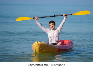 Man Paddling A Kayak Boat In The Sea