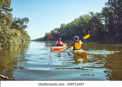Man Paddling In A Kayak On River.