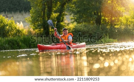 Man paddling with kayak on river for water sport