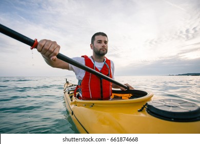 Man Paddling Sea Kayak. Close Up Of Man Kayaker Paddling Sea Kayak