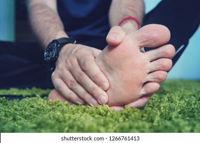 Man With Painful And Inflamed Gout On His Foot Around The Big Toe Area. Man's Hand Being Massaged A Foot